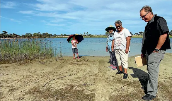  ??  ?? Ngati Kahu’s Tawakeiti Reti, Hikita Laing and Kiri Brown inspect tyre marks at Lake Waiporohit­a with NRC’s Will Trusewich.