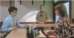  ?? ANDREW NICLA/THE REPUBLIC ?? Jordan Harb hands a copy of students’ safety proposals to a staff person for Gov. Doug Ducey, while a DPS trooper looks on.