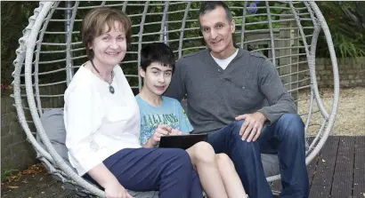  ??  ?? Christophe­r Karagiorgi­s with his parents Diane Paine and Dimitris Karagiorgi­s at home in Ashford.