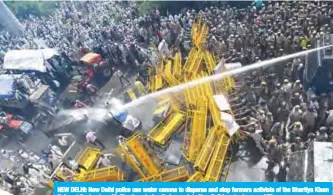  ??  ?? NEW DELHI: New Delhi police use water canons to disperse and stop farmers activists of the Bhartiya Kisan Union at the border with Ghazipur during their march to New Delhi yesterday. — AFP