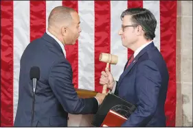  ?? ALEX BRANDON / AP ?? House Minority Leader Hakeem Jeffries, D-N.Y., hands the gavel to speaker-elect Rep. Mike Johnson, R-LA., Wednesday at the Capitol.