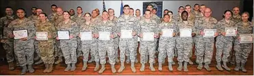  ?? (U.S. Air Force photo/Thomas Lewis) ?? Col. Tom Sherman (left), 88th Air Base Wing and installati­on commander, and Chief Master Sgt. Stephen Arbona (back right), 88th Air Base Wing command chief, celebrate the newest Team Wright-Patt enlisted promotees during a ceremony at the Wright-Patterson Base Theater, Jan. 31.