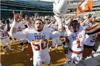  ?? Associated Press ?? Texas Longhorns offensive lineman Jake Raulerson, left, celebrates with wide receiver John Burt, right, after Texas defeated Baylor on Saturday in Waco, Texas.