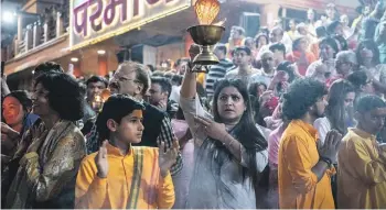  ?? GETTY IMAGES ?? An Indian Hindu devotee takes part in the nightly arti prayer ceremony at the Parmath Niketan ashram on the banks of the River Ganges in Rishikesh, India, in March. North Indian pilgrimage towns like Varanasi, Rishikesh and Haridwar serve as symbolic hubs of Hindu identity and pilgrimage, enabling the BJP to tap into religious fervour and historical narratives to strengthen its political base and influence.