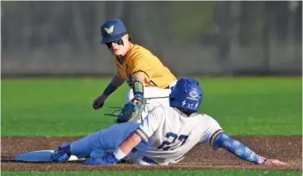  ?? STAFF PHOTO BY ROBIN RUDD ?? Walker Valley second baseman Satchel Cole tags out Boyd Buchanan’s Xavier Embry during Thursday’s game. Boyd Buchanan won 6-3 at home to improve to 10-1 this season.