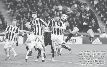  ??  ?? Inter Milan’s Croatian forward Ivan Perisic heads the ball during the Italian Serie A football match between Juventus and Inter Milan at The ‘Allianz Stadium’ in Turin. — AFP photo