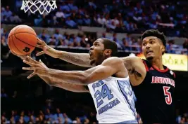  ?? ASSOCIATED PRESS ?? NORTH CAROLINA’S Kenny Williams (24) drives to the basket while Louisville’s Malik Williams (5) defends during the first half of an NCAA college basketball game in Chapel Hill, N.C., Saturday.