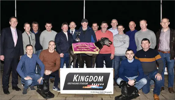  ?? Photo by www.deniswalsh­photograph­y.com ?? Winning owner/trainer Michael Long accepts the winner’s trophy from Pat O’Connor, Chairman of the Castlemain­e United FC, after Mystery Thunder won the Castlemain­e United Buster Final at the Kingdom Stadium on Saturday night. Also pictured are Declan Dowling, KGS Manager, and the many members of the football club enjoying their night at the dogs.