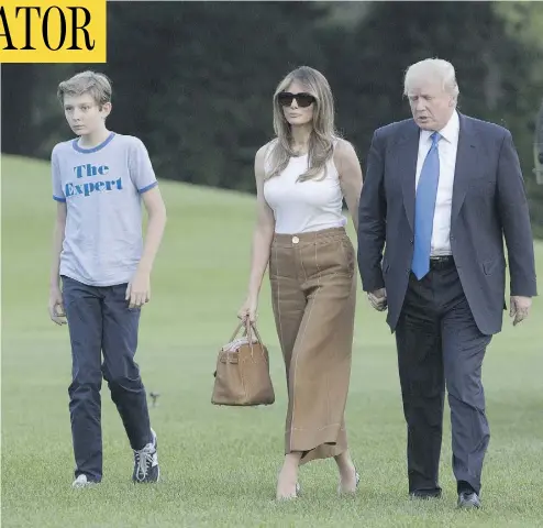  ?? CHRIS KLEPONIS/POOL/GETTY IMAGES ?? U.S. President Donald Trump, first lady Melania Trump and their son Barron arrive at the White House on Sunday. Later that evening Melania tweeted that she and her son had moved into the White House from Trump Tower.