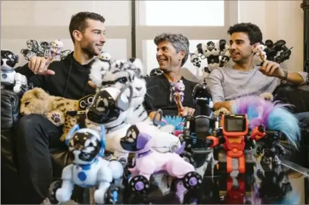  ?? RENAUD PHILIPPE, NEW YORK TIMES ?? Richard Yanofsky, centre, a founder of WowWee, poses for a photo with his sons, Michael, left, and Andrew amid an array of toys.