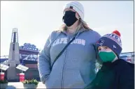  ?? Elise Amendola / Associated Press ?? Kelly Roccabello and her son, Giovanni, 6, speak to a reporter Monday outside the pro shop at Gillette Stadium in Foxborough, Mass.