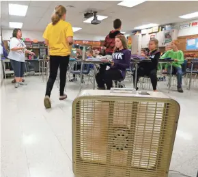  ?? RICK WOOD / MILWAUKEE JOURNAL SENTINEL ?? Teacher Connie Lichtenwal­b (left) keeps fans running constantly in her stuffy classroom in the Kiel School District. Taxpayers have rejected several referendum attempts to raise money for the district beyond limits set by the state.