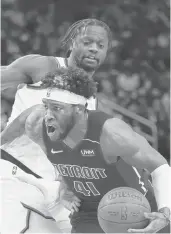  ?? CARLOS OSORIO/AP ?? Pistons forward Saddiq Bey drives as Knicks forward Julius Randle defends during the first half Wednesday in Detroit.