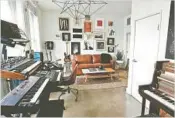  ??  ?? THE LOFT of musician Isom Innis and actress Carlson Young includes a studio area for Innis, left, and bedroom area, right. It’s an ideal setting for a toast with friends.