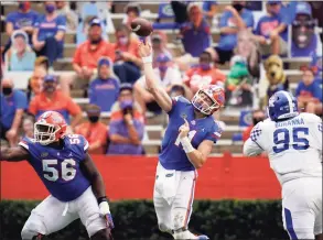  ?? John Raoux / Associated Press ?? Florida quarterbac­k Kyle Trask, center, throws a pass during the second half against Kentucky on Saturday in Gainesvill­e, Fla.