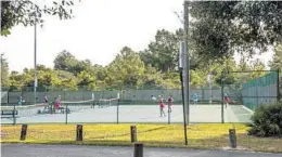  ?? ?? With 17 courts, tennis is the focal point of Shadow Bay Park.