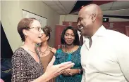  ??  ?? Honourable Kamina Johnson-Smith (left), minister of foreign affairs, greeting Jamaican-Canadian businessma­n Wes Hall during the cocktail reception of the screening of ‘WES’, at the Carib Theatre on October 19. Looking on is Yanique Forbes-Patrick,...