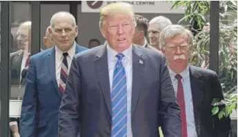  ?? SEAN KILPATRICK/ THE CANADIAN PRESS VIAAP ?? President Donald Trump leaves the G7 Leaders Summit in La Malbaie, Quebec, on Saturday with White House Chief of Staff John Kelly ( left) and National Security Adviser John Bolton.