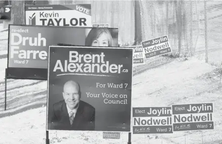  ?? Photos: Calgary Herald/Files ?? Election signs line the grass on 19th Street N.W. for Ward 7 candidates. Labour groups are endorsing incumbent Druh Farrell in the riding.