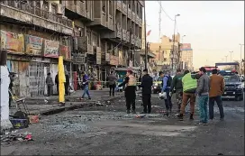  ?? ALI ABDUL HASSAN / ASSOCIATED PRESS ?? Iraqi security forces gather Monday at the scene of a double suicide bombing in central Baghdad. The bombers, believed affiliated with the Islamic State militant group, targeted Tayran Square during the morning rush hour.