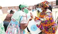  ??  ?? First Lady Auxillia Mnangagwa congratula­tes Mrs Caroline Ncube (wife to Chief Nhekatambe) who scooped the first prize during Amai’s cook out competitio­n in Lupane yesterday