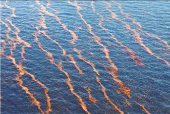  ?? Gerald Herbert / Associated Press 2010 ?? An oil spill is seen near the coast of Louisiana in 2010 after an explosion and collapse of the Deepwater Horizon oil rig a week earlier. As much as 176 million gallons of oil was spilled.