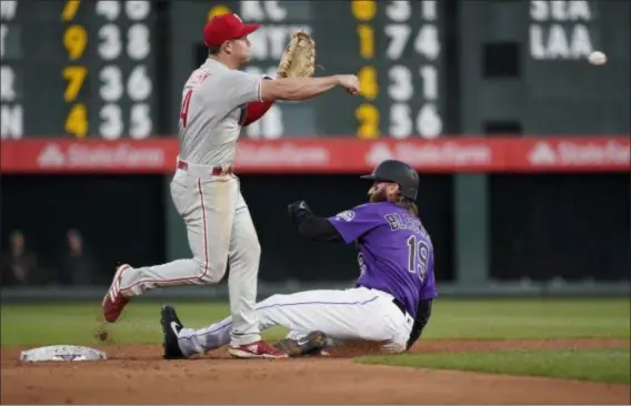  ?? THE ASSOCIATED PRESS FILE ?? Phillies utility player Scott Kingery makes a pivot at second and guns a throw to first over Charlie Blackmon in a game against the Rockies in Denver in April. Kingery was injured during that series on April 20 and is hoping to return to action soon.