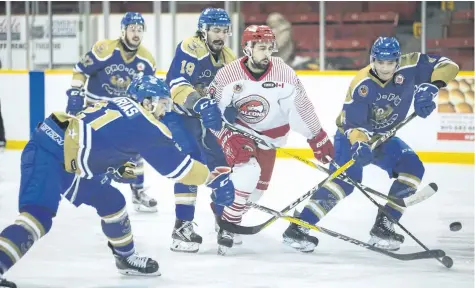  ?? BOB TYMCZYSZYN/STANDARD STAFF ?? Three Caledonia Corvairs players tie up St. Catharines Falcons Tanner Ferreira as he breaks in on ne during Game 4 of their Golden Horseshoe junior B playoff series Tuesday at Jack Gatecilff Arena.