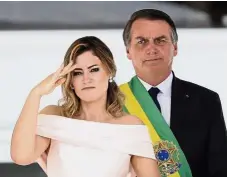  ??  ?? Ceremonial tradition: Bolsonaro looking on as his wife Michelle gives a military salute at the Planalto presidenti­al palace in Brasilia. — AP