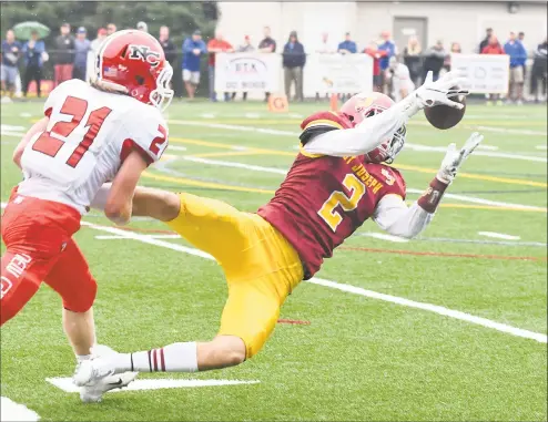  ?? Krista Benson / For Hearst Connecticu­t Media ?? St. Joseph’s Jesse Bike, right, makes a reception for a first down in front of New Canaan’s Nate Sibbett during their game Saturday in Trumbull. The Cadets won 28- 0.