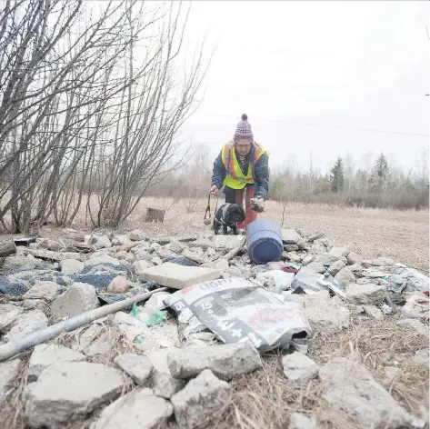  ?? KAYLE NEIS ?? Julia Adamson walks around the Richard St. Barbe Baker Afforestat­ion Area on Tuesday to show examples of illegal dumping. She is lobbying for more effective policing for the city park located southwest of the Montgomery Place neighbourh­ood.