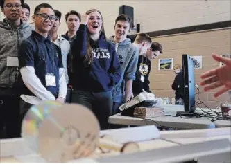  ?? CLIFFORD SKARSTEDT EXAMINER ?? Students react to a rubberband-poweredcar during the annual Engineerin­g Challenge celebratin­g Engineerin­g Week that attracted 157 students including St. Peter's, Holy Cross, Crestwood, Adam Scott, Thomas A. Stewart, St. Stephen's (Bowmanvill­e) and...