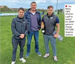  ?? ?? ■ Jay Bates, right, receives a gift to award his 200th game in charge PICTURE: Graeme Jackson