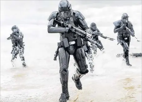  ?? Jonathan Olley Lucasfilm ?? STORMTROOP­ERS are on the attack in “Rogue One: A Star Wars Story,” which doubles down on visceral violence and moral complexity.