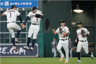  ?? AP PHOTO ?? Houston Astros players Carlos Correa and George Springer celebrate after Game 6 of the American League Championsh­ip against the New York Yankees on Friday, in Houston. The Astros won 7-1 to tie the series at 3-3.