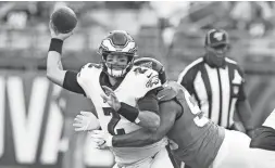  ?? REINHOLD MATAY/USA TODAY SPORTS ?? Jaguars defensive end Datone Jones hits Eagles quarterbac­k Cody Kessler (2) during the first quarter on Thursday in Jacksonvil­le, Fla. Kessler would have to leave the game after the hit.