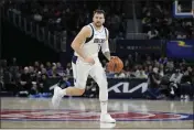  ?? CARLOS OSORIO — THE ASSOCIATED PRESS ?? Dallas Mavericks guard Luka Doncic brings the ball up court during the second half against the Detroit Pistons on Saturday in Detroit.