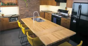  ?? Ben Sonenblum ?? Ben Sonenblum created this kitchen with mahogany cabinets and maple butcher block island. He is one of nine artisans who will appear at the Pittsburgh Home & Garden Show with MONMADE.