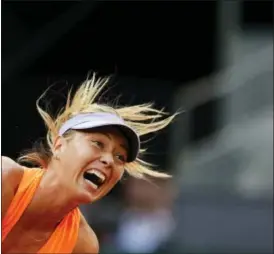  ?? FRANCISCO SECO — THE ASSOCIATED PRESS ?? Maria Sharapova from Russia serves against Eugenie Bouchard from Canada during a Madrid Open tennis tournament match in Madrid, Spain, Monday. Bouchard won 7-5, 2-6 and 6-4.