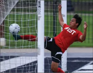  ?? Arkansas Democrat-Gazette/Mitchell Pe Masilun ?? SAVING GROUND: West goalie Leonardo Dominguez, of De Queen, tries to keep the ball from going into the net for a goal during the Arkansas High School Coaches Associatio­n boys all-star soccer game Wednesday night at Estes Stadium in Conway.