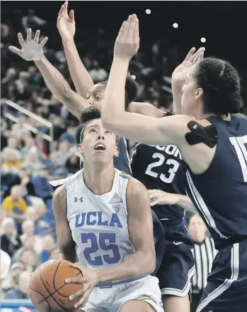  ?? Robert Gauthier Los Angeles Times ?? UCLA FORWARD Monique Billings has little room to work against Connecticu­t defenders during the first half at Pauley Pavilion. The Bruins were in it until a 16-0 run by the Huskies to end the third quarter.