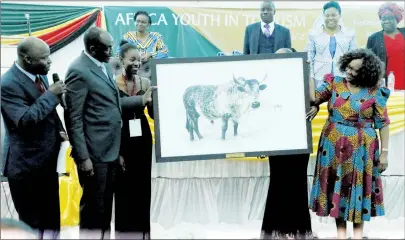  ??  ?? Acting President Kembo Mohadi is presented with a portrait after he officially opened the Africa Youth in Tourism Conference in Bulawayo. Looking on are the director of the School of Hospitalit­y and Tourism in Bulawayo, Mr Innocent Nezungai (left) and Tourism and Hospitalit­y Industry Minister Prisca Mupfumira (right). Following proceeding­s in the background are Informatio­n, Publicity and Broadcasti­ng Services Minister Monica Mutsvangwa (second from right)) and Secretary for Youth, Sports, Arts and Recreation Dr Thokozile Chitepo (extreme left),