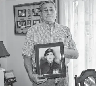  ?? ELIZABETH PATTERSON • CAPE BRETON POST ?? John Christoff holds up a photo of his older brother Jimmy who was killed in the Korean War in 1953.