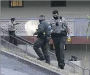  ?? PHOTO BY ETHAN SWOPE ?? Marin County Sheriff’s deputies inspect the scene of a shooting in Marin City on Tuesday.