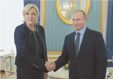  ?? KREMLIN POOL VIA AP ?? MEET-AND-GREET: French presidenti­al candidate Marine Le Pen of the far-right National Front party shakes hands with Russian President Vladimir Putin during a visit to the Kremlin yesterday. Le Pen says she wants to restore closer ties with Moscow.