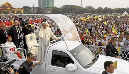  ?? AP ?? Pope Francis waves to Myanmar Catholics from his popemobile ahead of Wednesday’s Mass.—