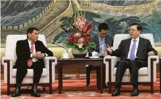  ?? Wu Hong / Associated Press ?? Philippine­s President Rodrigo Duterte, left, joins Zhang Dejiang, chairman of the Standing Committee of the National People’s Congress of China, during a meeting Thursday in Beijing.