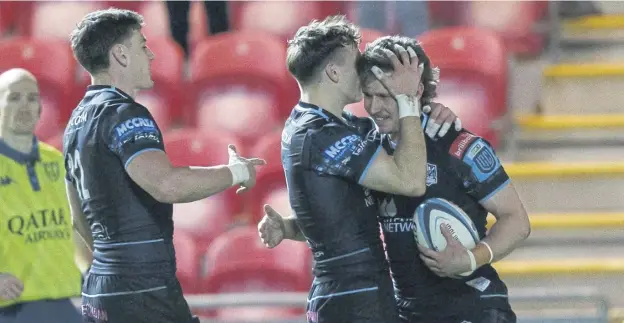  ?? ?? Kyle Rowe of Glasgow celebrates with his team-mates after scoring his second try in Saturday evening’s 45-3 win over Scarlets in the United Rugby Championsh­ip