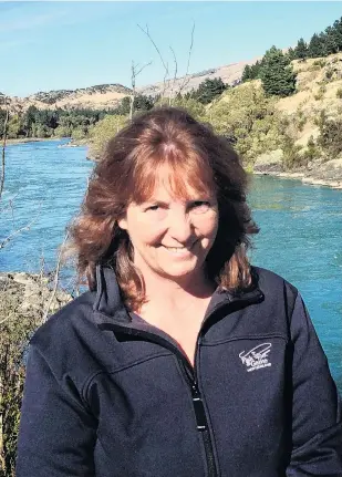  ?? PHOTO: SUPPLIED ?? The great outdoors . . . Otago Fish and Game councillor Vicky White is flanked by the Clutha River near her home town of Roxburgh. Ms Whyte is encouragin­g more women to get involved in both fishing and hunting and Fish and Game governance.