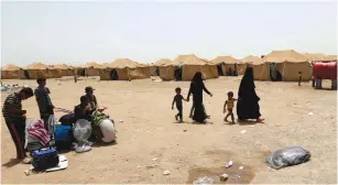  ?? (Thaier al-Sudani/Reuters) ?? IRAQIS WHO FLED Falluja because of Islamic State violence gather at a refugee camp south of the city on Wednesday.